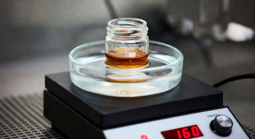 Warming cannabis distillate in a hot water bath before filling a cartridge